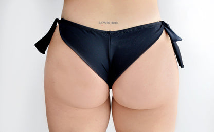Black brasil bikini bottom with bow sides worn by a sunlover swimwear model (Colour: BLK)