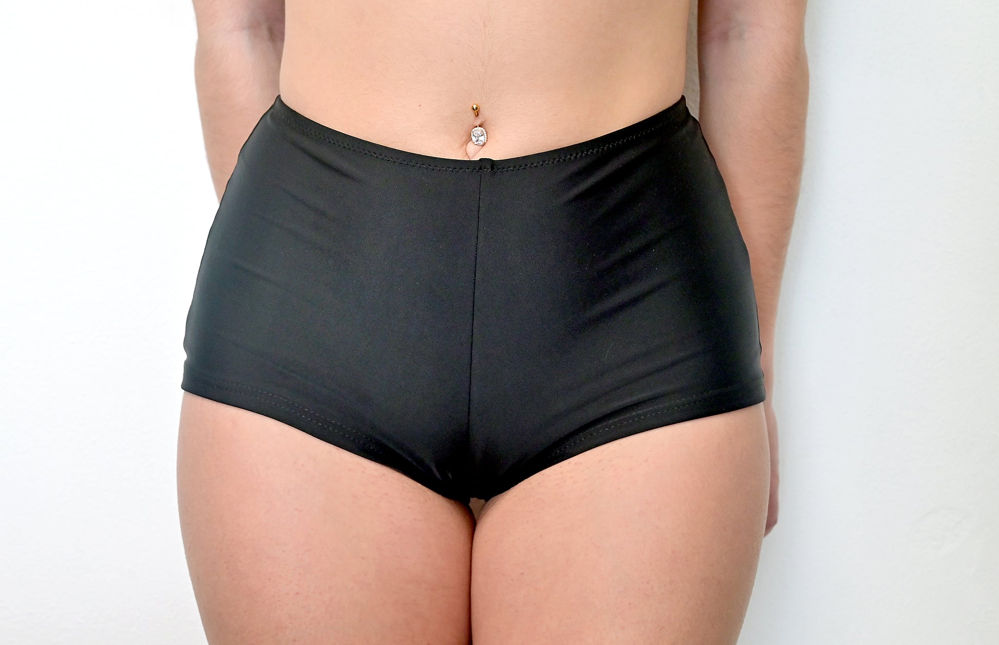 Sunlover Swimwear model wearing black swim shorts on a plain background (Colour: BLK)