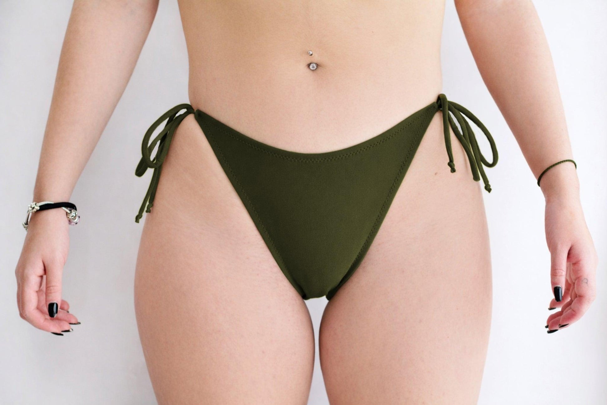 Sunlover Swimwear model wearing a classic bosque bikini bottom with ties on a plain background (Colour: BOS)