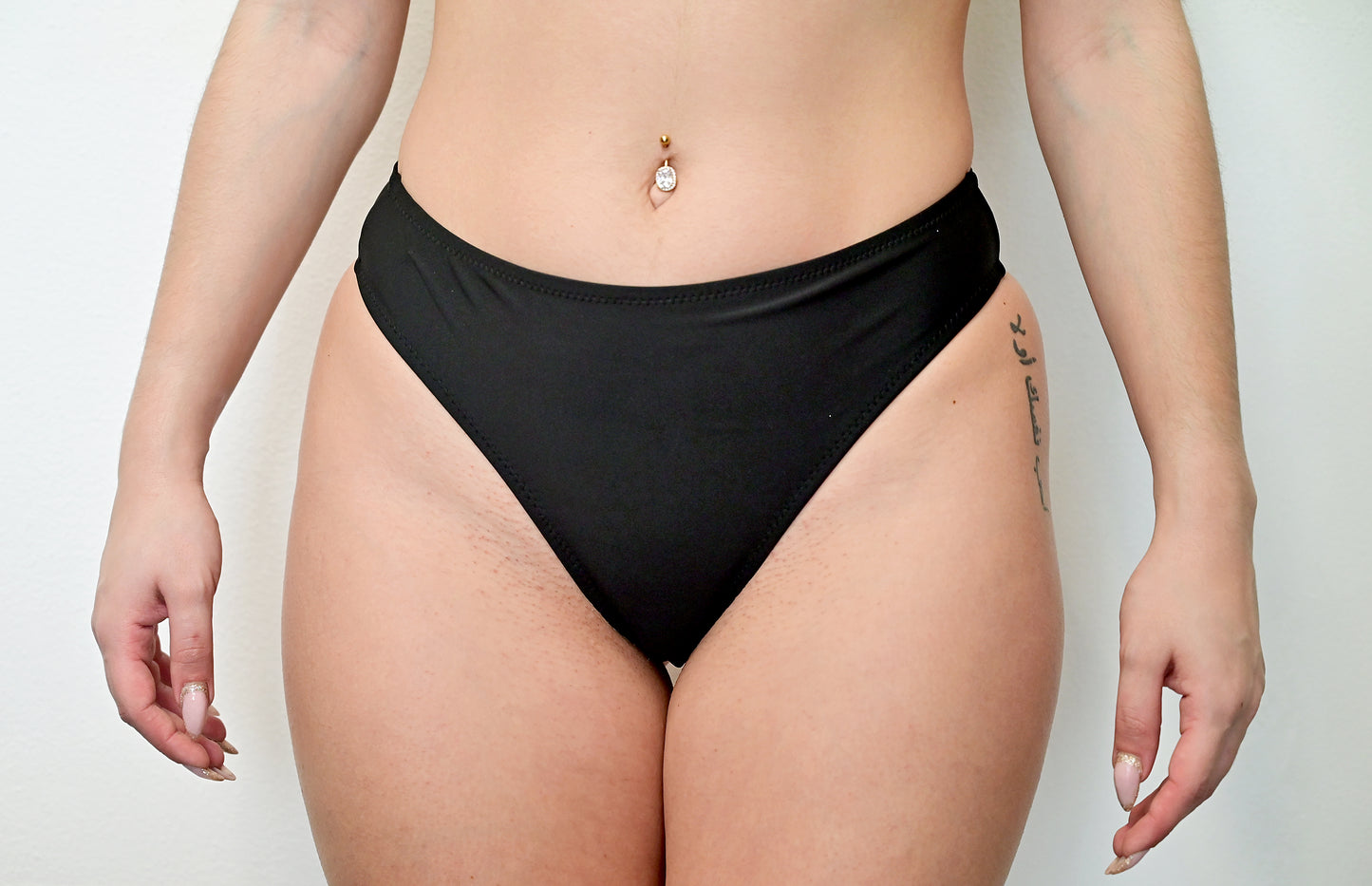 Sunlover Swimwear model wearing a black G-string bikini (Colour: BLK)