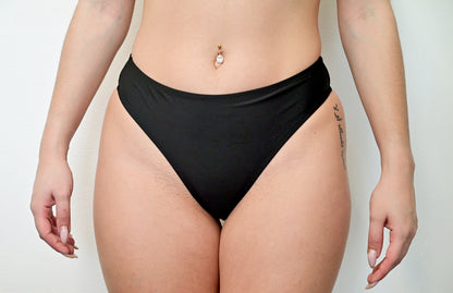 Sunlover Swimwear model wearing a black G-string bikini (Colour: BLK)