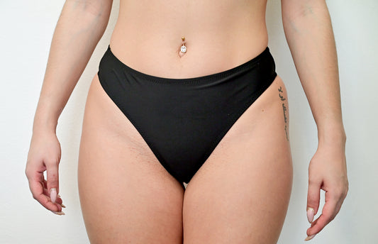 Sunlover Swimwear model wearing a black G-string bikini (Colour: BLK)