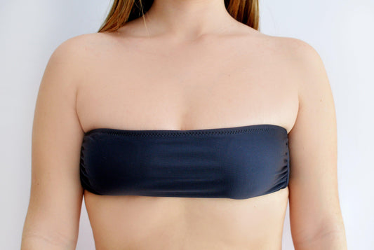 Black strapless top worn by a sunlover swimwear model