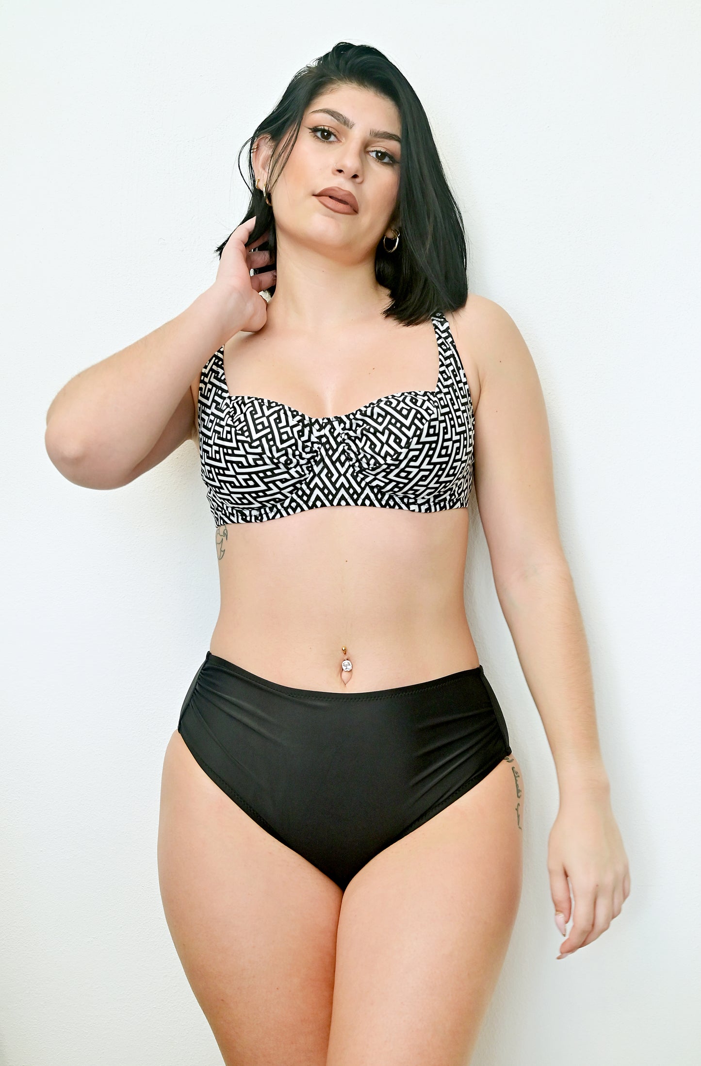 Sunlover swimwear model wearing a black and white patterned bikini top and black high-waisted bottoms on a white background (Colour: P25)