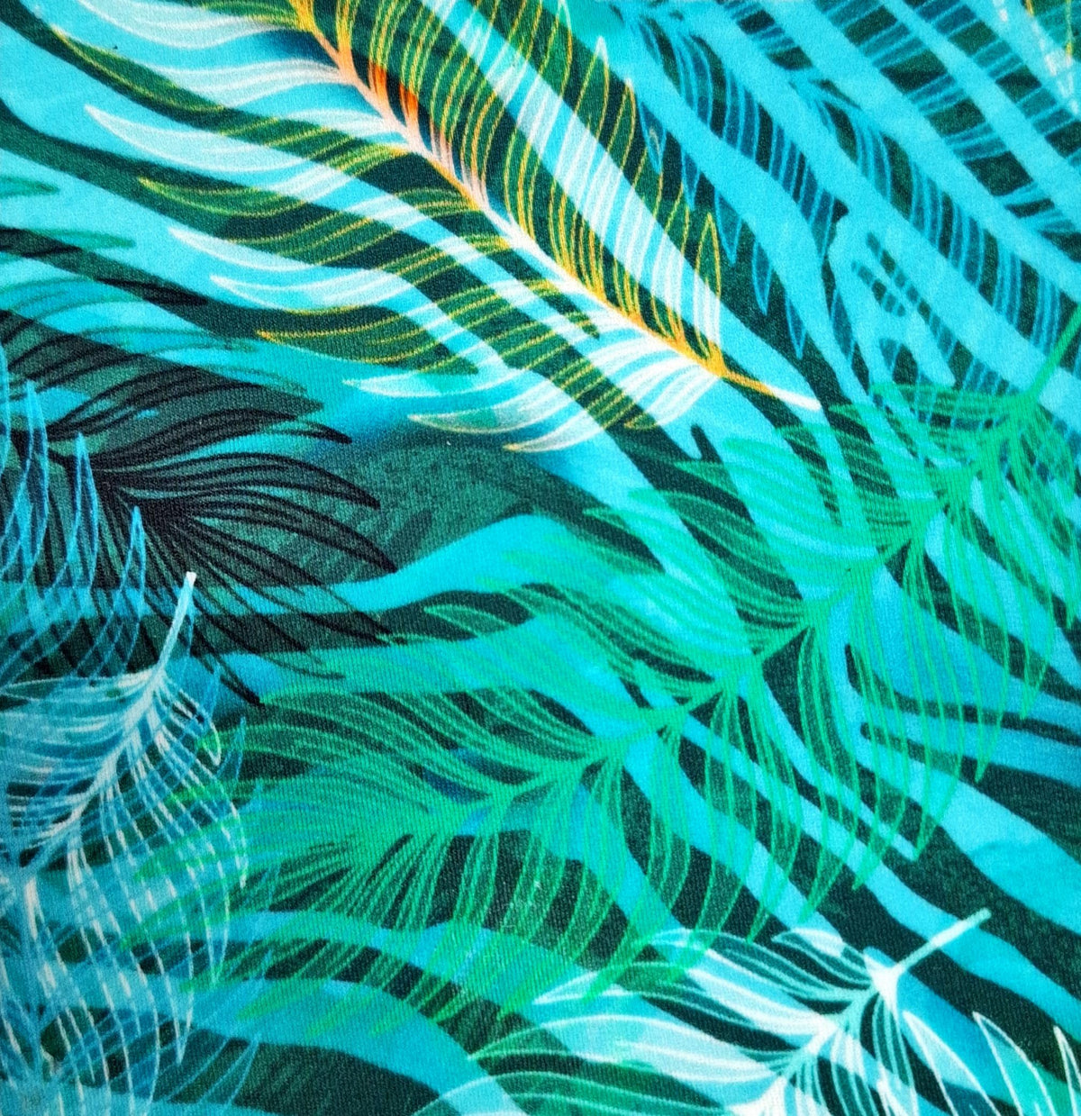 Close-up of a fabric with a tropical leaf pattern in teal, green, and black (Colour: P24)
