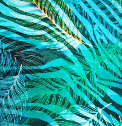 Close-up of a fabric with a tropical leaf pattern in teal, green, and black (Colour: P24)